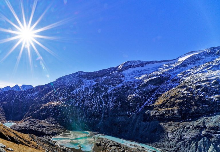 glacier lake beneath steep mountain peaks